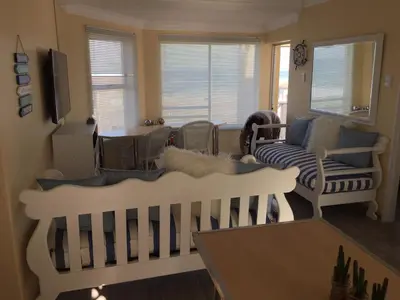 a living room with a crib and a couch at Huisi by di C in Hermanus