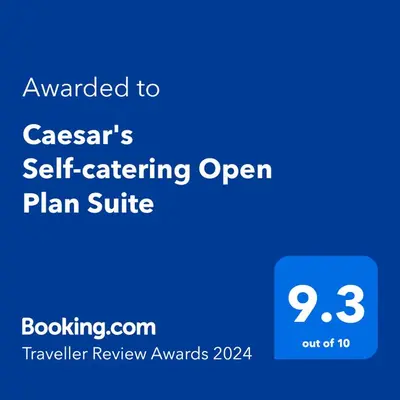 a screenshot of a cell phone with the text upgraded to casserars self catering at Caesar's Self-catering Open Plan Suite in Somerset West