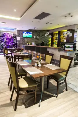 a dining room with a table and chairs at Hotel Verde Cape Town Airport in Matroosfontein