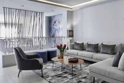 a living room with a couch and a table at Kianga in Gordonʼs Bay