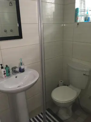 a bathroom with a toilet and a sink at Pelican Accommodation Ottery in Cape Town