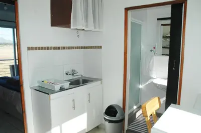 a bathroom with a sink and a toilet at Pelican Accommodation Ottery in Cape Town