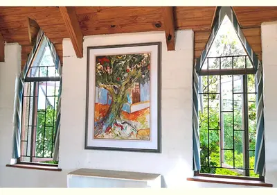 a painting of a tree on a wall with windows at Studio on McLeod - Private Self-catering Apartment in Somerset West