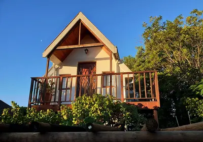a small house with a porch and a balcony at Studio on McLeod - Private Self-catering Apartment in Somerset West