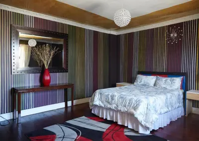 a bedroom with a bed and a vase on a rug at Liziwe's Guest House in Matroosfontein