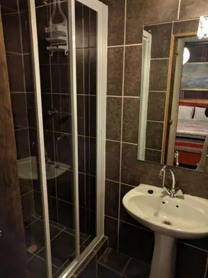 a bathroom with a shower and a sink at Liziwe's Guest House in Matroosfontein