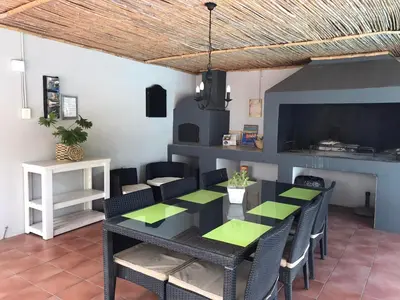 a dining room with a black table and chairs at B&B Sauvignon Country Lodge in Wellington
