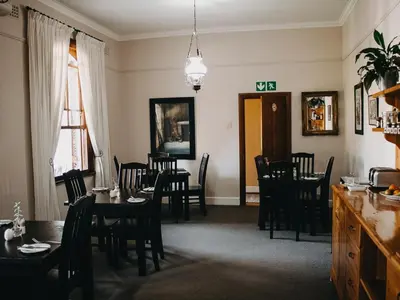 a dining room with a table and chairs in it at Cummings Guesthouse in Wellington