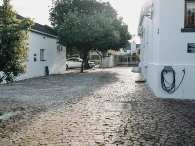 a cobblestone street next to a white building at Cummings Guesthouse in Wellington