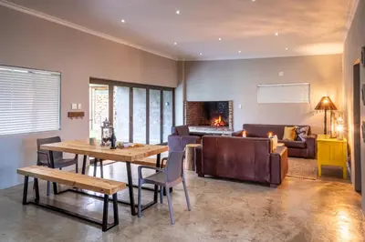 a living room with a table and a couch at Steenbok Farm Cottages Steenbok cottage in Wolseley