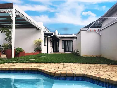 a house with a swimming pool in the yard at Selton Guesthouse in Cape Town