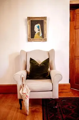 a white couch with a black pillow in a room at Cape Dutch @ Keerweder in Franschhoek