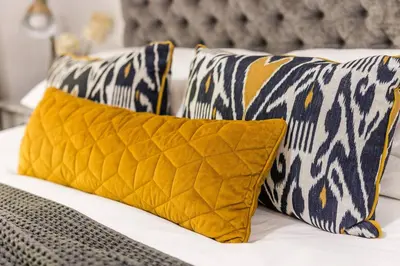 a bed with two yellow pillows on it at Casa Bella Stellenbosch - Jan Cats No 4 in Stellenbosch
