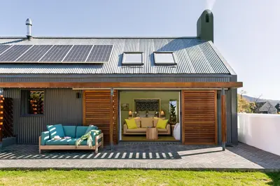 a house with solar panels on the roof at Bosjes - Herehuis in Breerivier