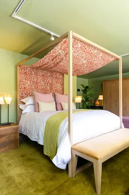 a bedroom with a large bed with a canopy at Bosjes - Herehuis in Breerivier