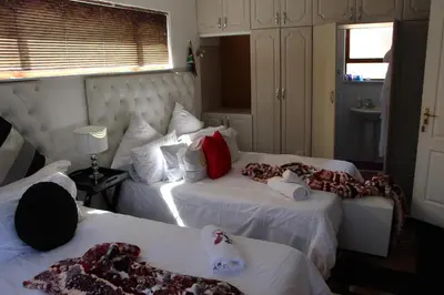 a hotel room with two beds with blankets on them at Turning Point Bed & Breakfast in Cape Town
