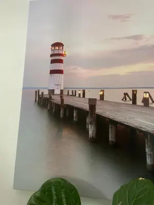 a lighthouse sitting on a pier next to the water at Zagorski’s Bed and breakfast in Bloubergstrand