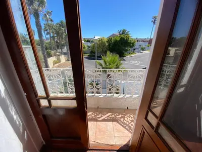 an open door to a balcony with a view of a street at Zagorski’s Bed and breakfast in Bloubergstrand