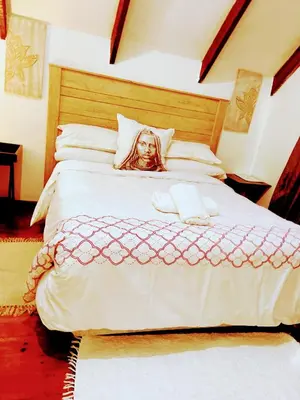 a woman laying on top of a large bed at Zagorski’s Bed and breakfast in Bloubergstrand