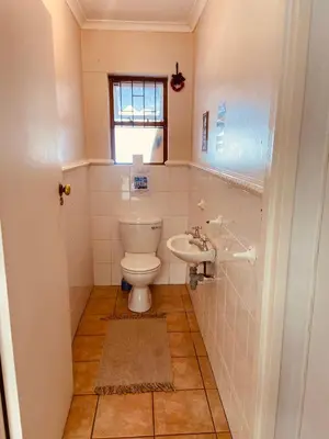 a bathroom with a toilet and a sink at Zagorski’s Bed and breakfast in Bloubergstrand