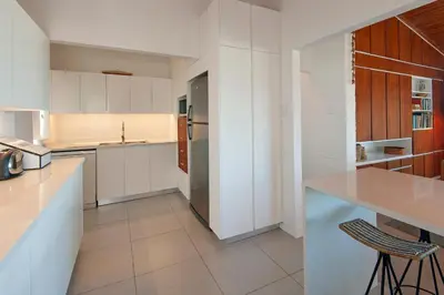 a kitchen with white cabinets and a counter top at Views Views Views in Hermanus