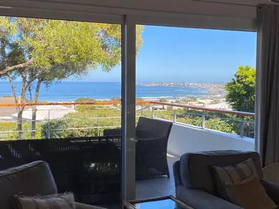 a living room with a view of the ocean at Views Views Views in Hermanus