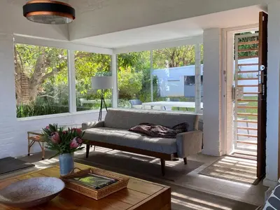 a living room with a couch and a large window at Views Views Views in Hermanus