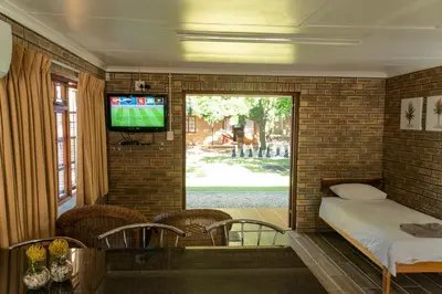 a room with a bed and a tv in a brick wall at De Hollandsche Molen in Hou Moed