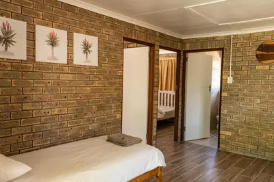 a bedroom with a brick wall and a bed at De Hollandsche Molen in Hou Moed