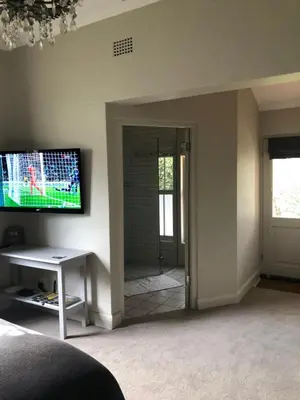 a living room with a tv on a wall at Elton in Cape Town