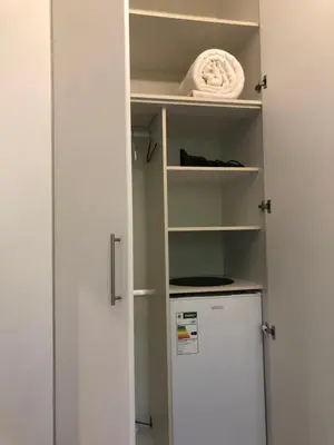 a kitchen with a refrigerator and a shelf at Elton in Cape Town