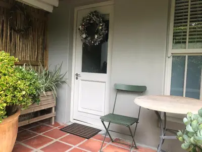 a table and a chair next to a door at Elton in Cape Town