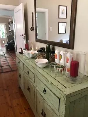 a wooden dresser with a mirror on top of it at Elton in Cape Town