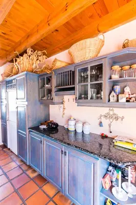 a kitchen with blue cabinets and a refrigerator at Die Wasbak in Greyton