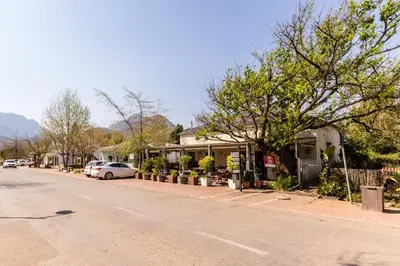 a street with cars parked on the side of a road at Die Wasbak in Greyton
