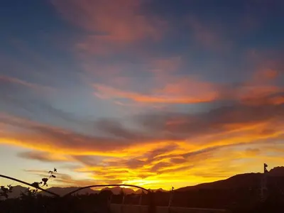 a plane flying in the sky at sunset at Worcester the Karoo Guest Room in Worcester