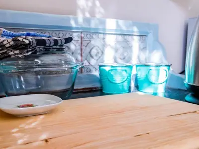 a counter top with a bowl and a jar of water at Worcester the Karoo Guest Room in Worcester