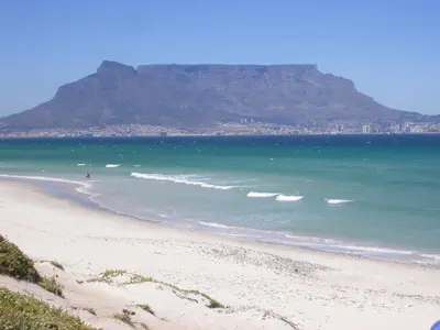 a view of a beach with a mountain in the background at Atlantic Blue Villa at Pilots in Cape Town