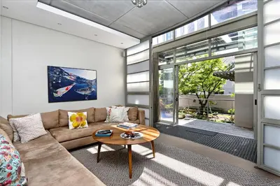 a living room with a couch and a table at Atlantic Blue Villa at Pilots in Cape Town
