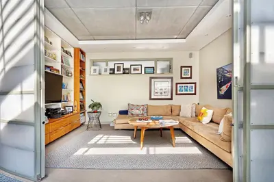 a living room with a couch and a table at Atlantic Blue Villa at Pilots in Cape Town