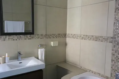 a bathroom with a sink and a mirror at Arlogenix in Durbanville