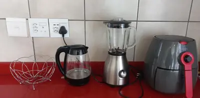 a kitchen counter with a blender and a coffee maker at Arlogenix in Durbanville