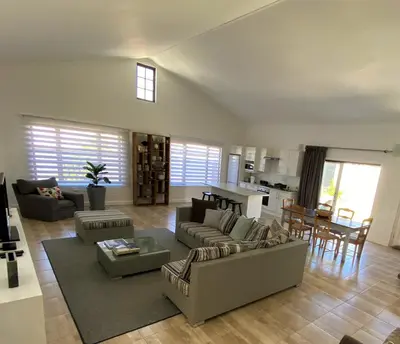 a large living room with a couch and a table at The Lily House Hermanus in Hermanus
