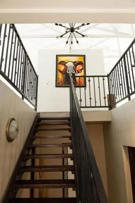 a staircase in a building with a painting on the wall at Staymore in Stellenbosch