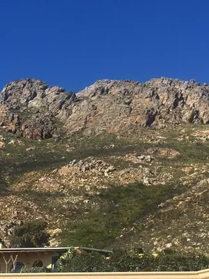 a mountain with a house in front of it at Flavours at 34 in Gordonʼs Bay
