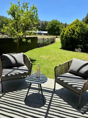 two couches and a table on a patio at Lynx Wine Estate in Franschhoek