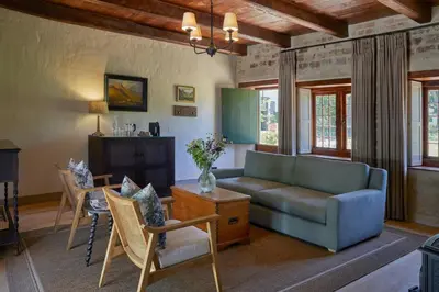 a living room with a couch and a table at Blaauwklippen Manor by NEWMARK in Stellenbosch