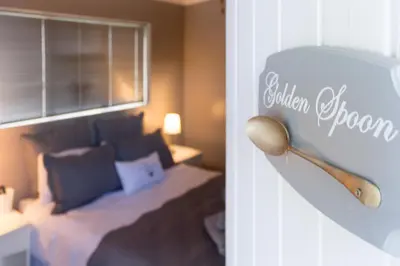 a bedroom with a bed and a wooden spoon at The Vintage Crane Guest House in Caledon