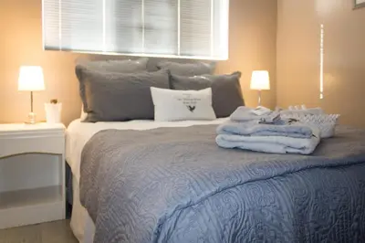 a bedroom with a bed with towels on it at The Vintage Crane Guest House in Caledon