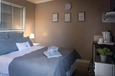 a bedroom with a bed with towels on it at The Vintage Crane Guest House in Caledon